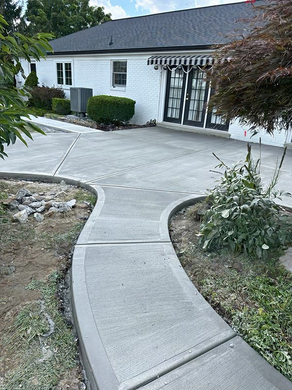 Decorative concrete walkway and patio by Trademark Outdoor Services